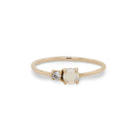 Front view of petite moonstone and round diamond ring set in 14 kt yellow gold.