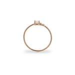 Side view of petite moonstone and round diamond ring set in 14 kt yellow gold.