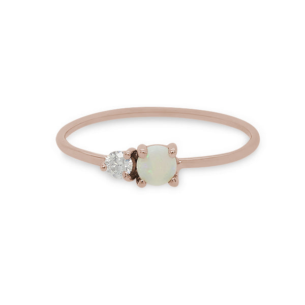 
                  
                    Load image into Gallery viewer, Front view of a cabochon opal and round diamond ring on a dainty band cast in 14 kt rose gold by King and Curated.
                  
                