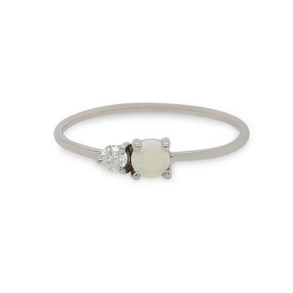 
                  
                    Load image into Gallery viewer, Front view of a cabochon opal and round diamond ring on a dainty band cast in 14 kt white gold by King and Curated.
                  
                