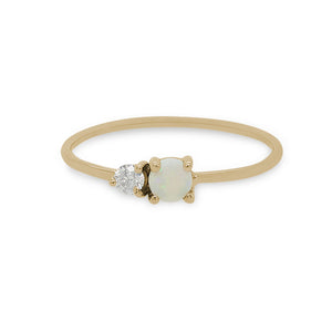
                  
                    Load image into Gallery viewer, Front view of a cabochon opal and round diamond ring on a dainty band cast in 14 kt yellow gold by King and Curated.
                  
                
