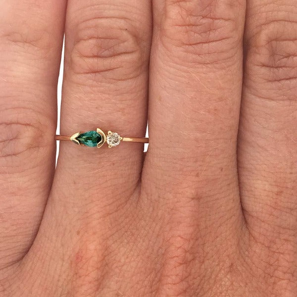
                  
                    Load image into Gallery viewer, Pear cut, green tourmaline and diamond ring cast in 14 kt yellow gold on left ring finger.
                  
                