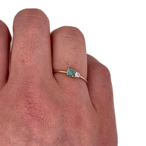 
                  
                    Load image into Gallery viewer, Round cut green tourmaline and diamond ring cast in 14 kt yellow gold on wearer&amp;#39;s right ring finger for scale.
                  
                