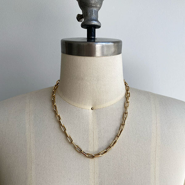 
                  
                    Load image into Gallery viewer, Front view of paperclip chain on dress form Shown at longest necklace length. Chain is cast in 14kt yellow gold.
                  
                