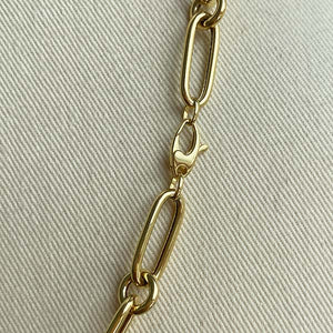 
                  
                    Load image into Gallery viewer, Close up of paperclip with round links and oval lobster clasp, cast in 14kt yellow gold.
                  
                