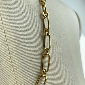
                  
                    Load image into Gallery viewer, Close up of paperclip with round links cast in 14kt yellow gold.
                  
                