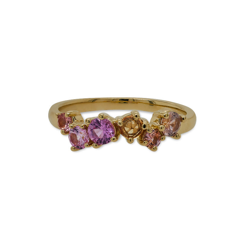 Front view of a 14 kt yellow gold band with 6 round, rose cut sapphires ranging in purple, orange, and yellow colors and gradually ranging in size as well.