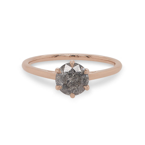 Front view of a round cut salt and pepper diamond ring with a 6 prong claw style setting, and cast in 14 kt rose gold.
