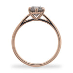 Side view of a round cut salt and pepper diamond ring with a 6 prong claw style setting, and cast in 14 kt rose gold.