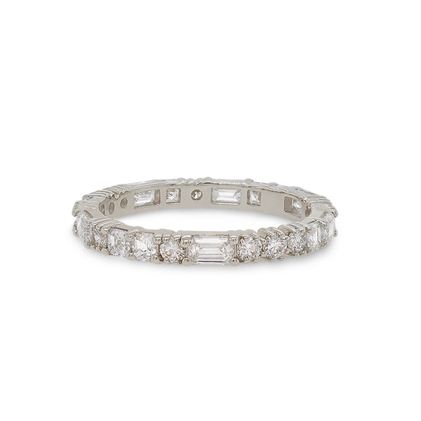 Front view of a diamond eternity band with round, asscher and baguette cut diamonds cast in 14 kt white gold.