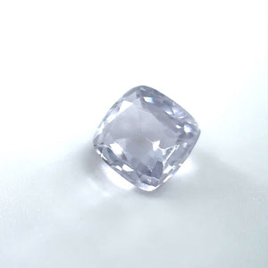 
                  
                    Load image into Gallery viewer, 3/4 view of a 1.30 ct. cushion cut pale lilac sapphire on white background.
                  
                