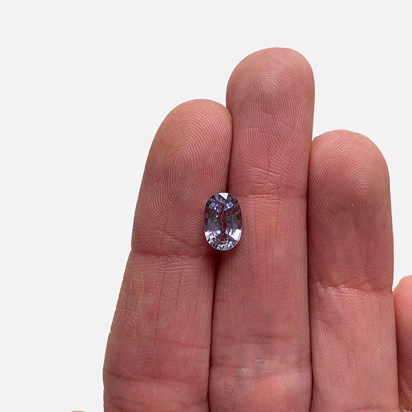 
                  
                    Load image into Gallery viewer, Front view of 1.46 ct. light blue-violet and elongated oval sapphire on ladies hand for scale.
                  
                