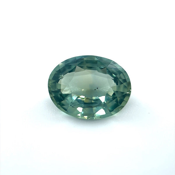 
                  
                    Load image into Gallery viewer, View of an oval 2.06 ct. blue-green sapphire on white background.
                  
                