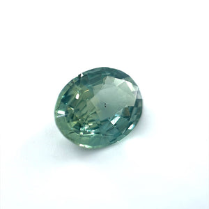 
                  
                    Load image into Gallery viewer, 3/4 view of an oval 2.06 ct. blue-green sapphire on white background.
                  
                