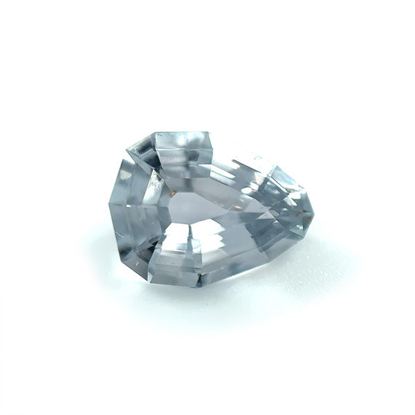 View of a 2.08 ct. geometric pear-shaped shield cut grey sapphire on white background.