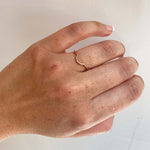 front view on left ring finger of thin arch shadow band cast in 14kt rose gold.