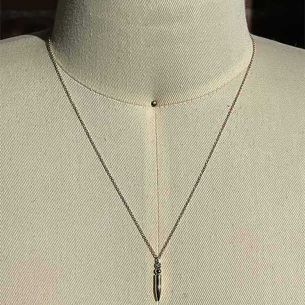 
                  
                    Load image into Gallery viewer, A large spike diamond necklace cast in 14 kt yellow gold on a dress form for scale.
                  
                