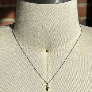 
                  
                    Load image into Gallery viewer, A small spike diamond necklace cast in 14 kt white gold on a dress form for scale.
                  
                
