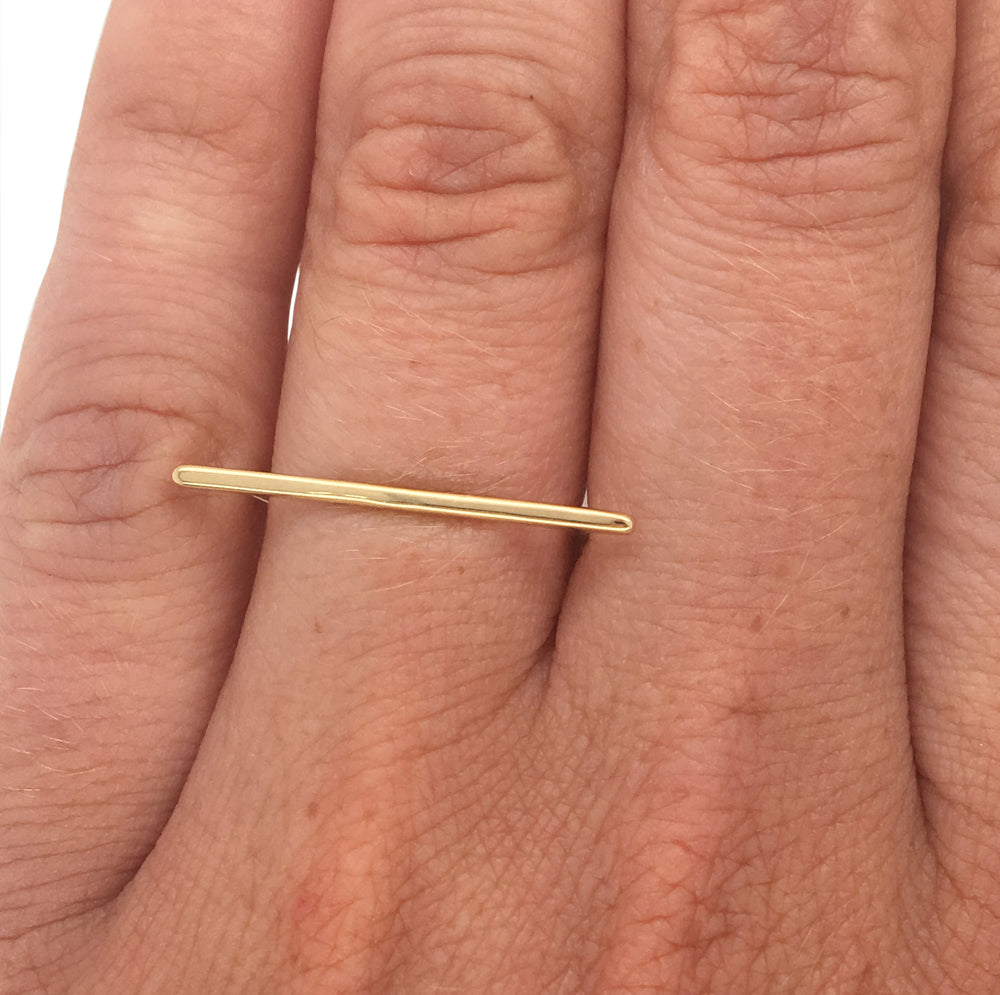 
                  
                    Load image into Gallery viewer, Bar shaped ring cast in 14 kt yellow gold on left ring finger.
                  
                