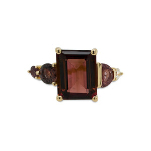 
                  
                    Load image into Gallery viewer, Front view of an asymmetrical, emerald cut deep red tourmaline ring with a half moon cut and round cut pink sapphires and diamonds cast in 14 kt yellow gold.
                  
                