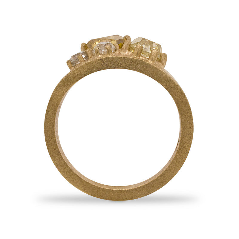 
                  
                    Load image into Gallery viewer, Through the finger view of a 14 kt yellow gold, sand blasted, tapering cigar band with 5 yellow and white mine cut diamonds weighting 2.45 tcw.
                  
                