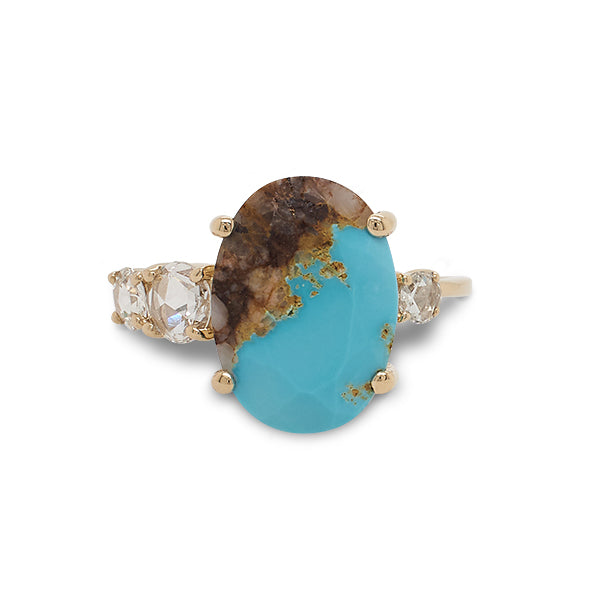 Front view of an asymmetrical rose cut turquoise ring flanked by 3 rose cut diamonds cast in 14 kt yellow gold by King + Curated.