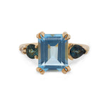 Front view of a large, emerald cut topaz, tourmaline and diamond ring cast in 14 kt yellow gold.