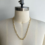 Front view of paperclip chain on dress form, cast in 14kt yellow gold.