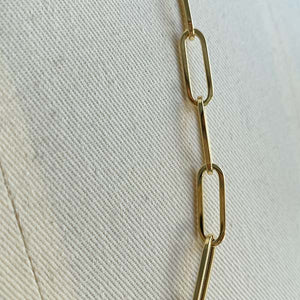 
                  
                    Load image into Gallery viewer, Close up image of paperclip links cast in 14kt yellow gold.
                  
                
