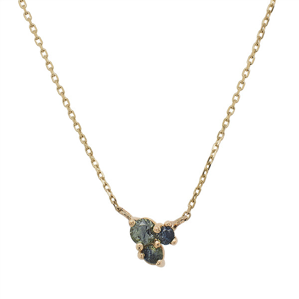 Front view of a triple cluster blue green sapphire necklace cast in 14 kt yellow gold by King + Curated in Beacon, NY.