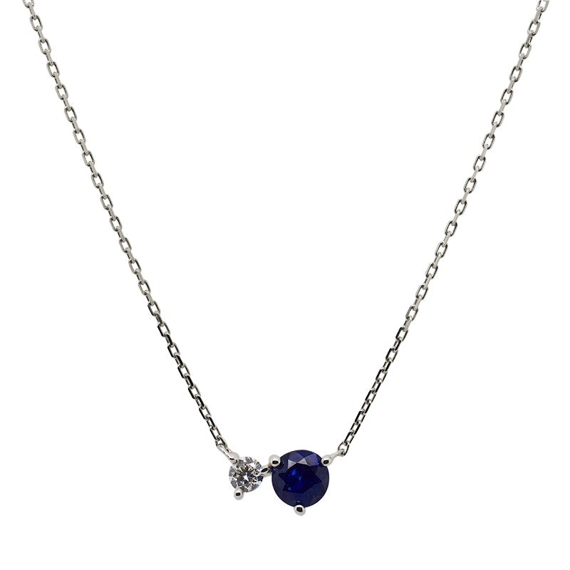 
                  
                    Load image into Gallery viewer, Front view of a round cut blue sapphire and diamond necklace made of solid 14 kt white gold.
                  
                