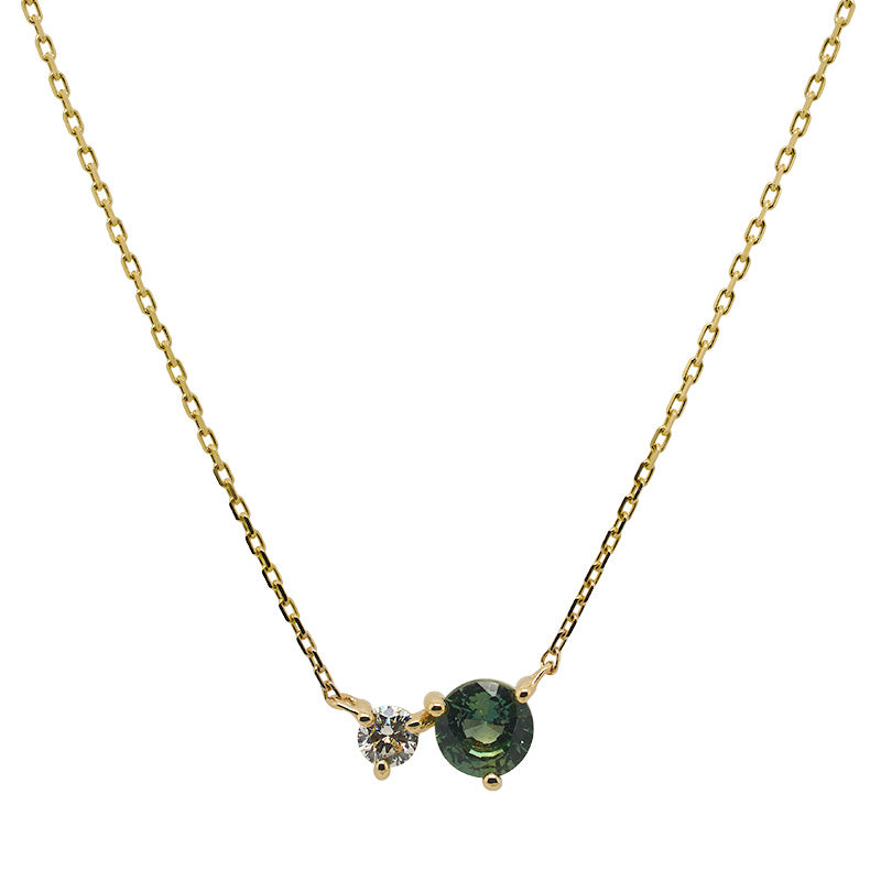 Front view of a round cut green sapphire and diamond necklace made of solid 14 kt yellow gold.