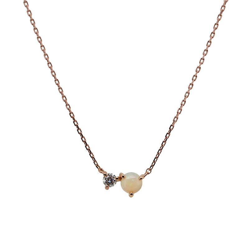 Front view of an east west set opal and 0.06 ct. white diamond pendant necklace cast in 14k rose gold.