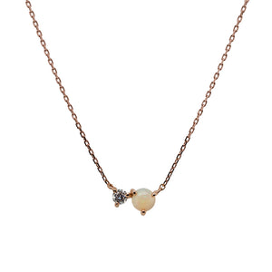 
                  
                    Load image into Gallery viewer, Front view of an east west set opal and 0.06 ct. white diamond pendant necklace cast in 14k rose gold.
                  
                